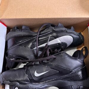 Nike Black Cleats with White Swoosh Detail